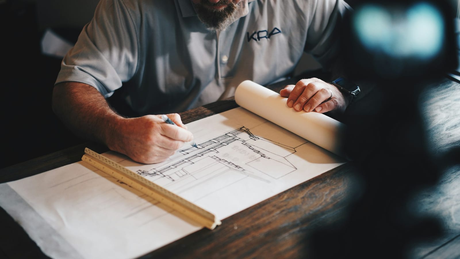 A CONQRA architect drawing a building elevation by hand